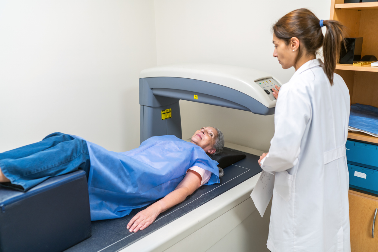 Elderly Woman Receives Bone Density Scan in Medical Facility